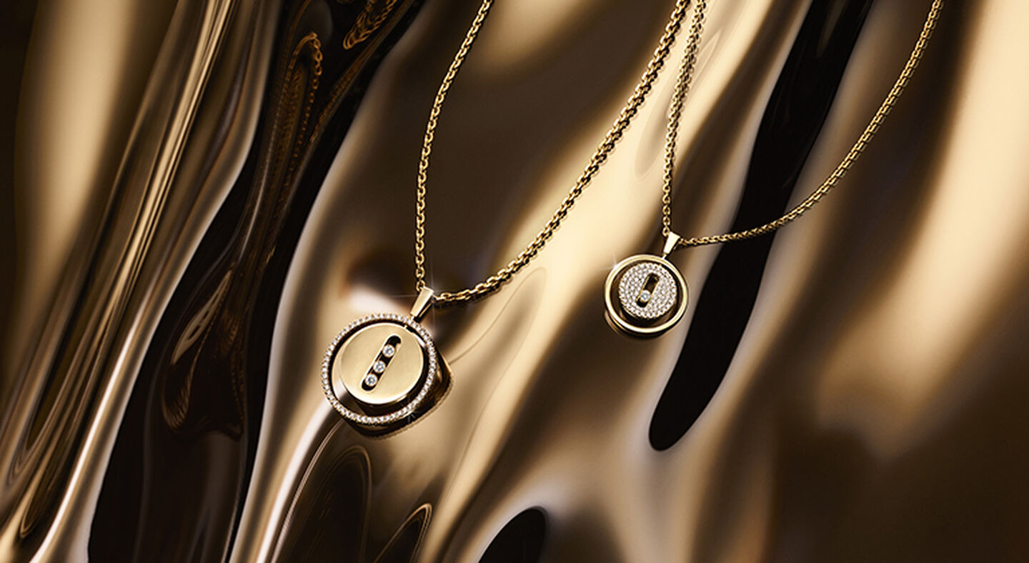 Two Messika Lucky Move diamond necklaces on a gold background.